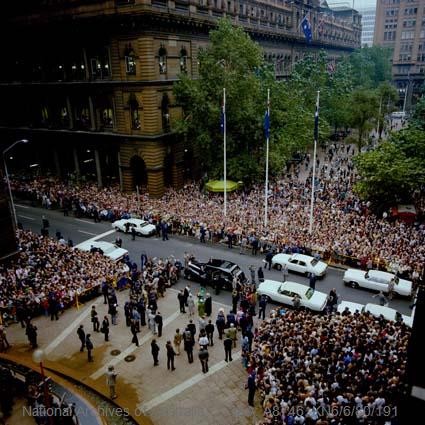 Crowds watch the Royal Family cavalcade at Martin Place, Sydney