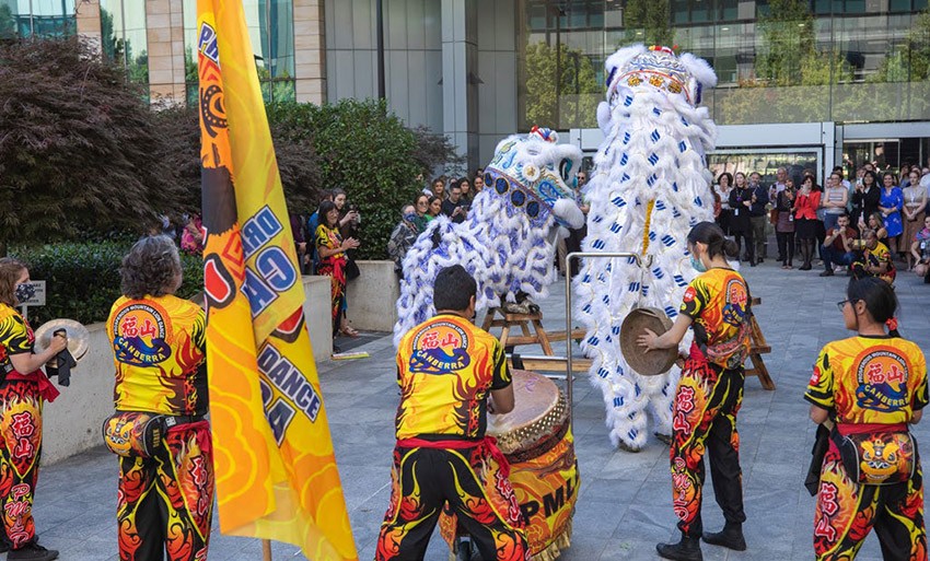 Lion dancing ceremony outside PM&C with 2 lions and 5 other persons performing in front of PM&C employees