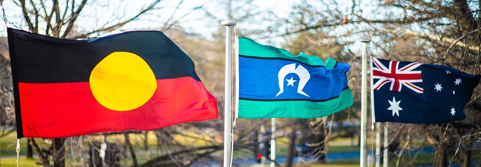 The Australian Aboriginal Flag, Torres Strait Islander Flag and Australian National Flags flying outside the Department's building