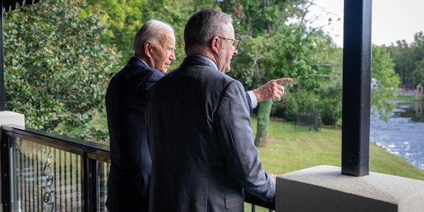 Prime Minister Anthony Albanese and President of the United States Joseph R. Biden Jr. standing on a balcony looking out over a river.