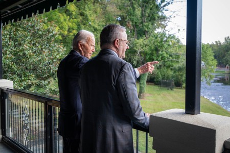 Prime Minister Anthony Albanese and President of the United States Joseph R. Biden Jr. standing on a balcony looking out over a river.