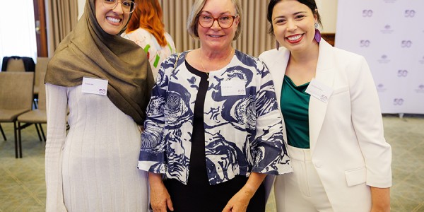 Tooba Jan, Trish Bergin and Georgina Ridley pose for a group photograph while attending an event celebrating the Office for Women’s 50th anniversary.