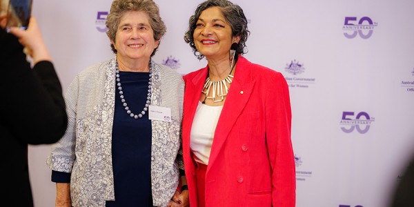 Helen L'Orange AM and Padma Raman PSM posing for a photograph while attending an event celebrating the Office for Women’s 50th anniversary.