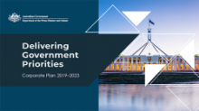Blue tile at left with the text: Delivering Government Priorities. At right is a picture of a large building with a flag on top of it.