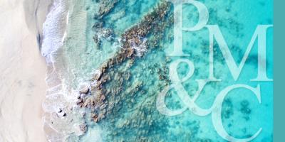 Aerial shot of sand, sea and rocks