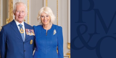 HRH King Charles III and Queen Camilla wearing blue suits.